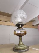 A Victorian oil lamp complete with chimney and original acid etched shade.