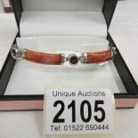 A garnet and hardstone set bracelet in silver with safety catch.