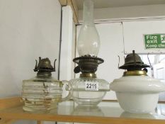 2 oil lamp fonts (one with chimney) and a hand held oil lamp.