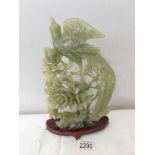 A piece of carved jade depicting pheasant and other birds.
