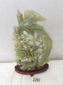 A piece of carved jade depicting pheasant and other birds.