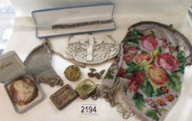 A mixed lot including evening hand bags, costume jewellery, record needle tins,