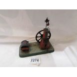 An early 20th century German tin plate clock work steam engine.