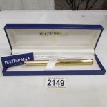 A cased Waterman gold plated Godron fountain pen featuring Guilloche design.