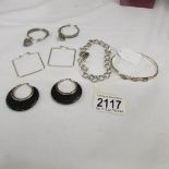 2 pairs of hoop earrings in silver with one fashioned with pendant hearts,