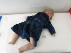 A 19th century doll marked CM France with porcelain head and composition body, in original costume.