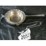A silver strainer and silver sugar nips