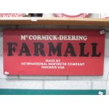 A McCormick-Deering Farmall painted metal sign (approximately 90 x 41cm)