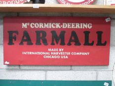 A McCormick-Deering Farmall painted metal sign (approximately 90 x 41cm)