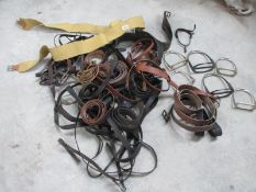 A big lot of vintage stirrups and horse tack.