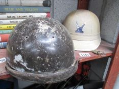 2 old motorcycle helmets