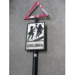 A cast iron Children playing street sign