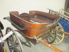 A 4 seat rear entry singel horse pony trap in original livery.