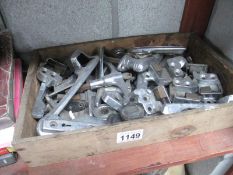 A box of assorted door and window handles