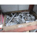 A box of assorted door and window handles