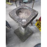 A vintage concrete bird bath.