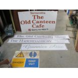 A large The Old Canteen café sign and other signs