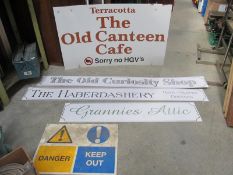 A large The Old Canteen café sign and other signs