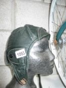 A vintage green leather motorcycle helmet size 60