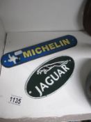 2 cast iron Jaguar and Michelin signs