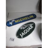 2 cast iron Jaguar and Michelin signs