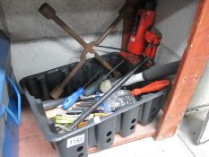 A box of miscellaneous tools including bottle jack