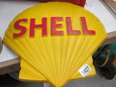 A large cast iron shell emblem wall plaque.