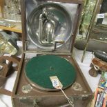 A 1920's Decca 'Trench' portable gramaphone featuring internal aluminium speaker and winding handle,