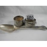 2 silver napkin rings and a silver spoon.