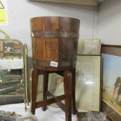 A brass bound planter on stand.