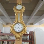 A Victorian cast iron and gilded clock with aneroid barometer, maker J J Wainwright & Co.