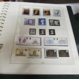 2 albums of Elizabeth II stamps including commemorative and older British stamps.