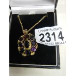 A Victorian mixed cut amethyst pendant in gold cannetille setting on yellow metal chain.