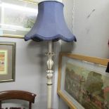 A painted standard lamp with shade.