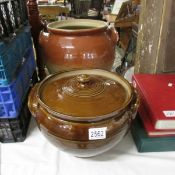 A large stoneware lidded pot and a large example missing lid.