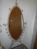 A metal framed oval cheval mirror.