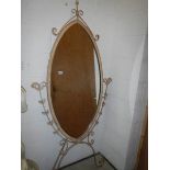 A metal framed oval cheval mirror.