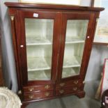 A display cabinet with 4 drawers.