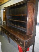 A Georgian oak dresser, approximately 96.75'' wide x 80'' high x 22.75'' deep.