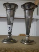 A pair of hall marked silver spill vases,