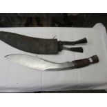 A second world war kukri, 2 kit bags and a pair of military boots.