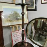 A mahogany torchere.