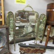 A triple brass firescreen with star cut mirrors.