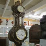 A cast iron barometer on oak back, glass a/f.