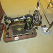 A vintage Empress sewing machine (no cover).