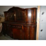 A large oak sideboard with cabinet top.