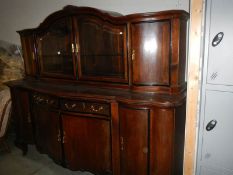 A large oak sideboard with cabinet top.