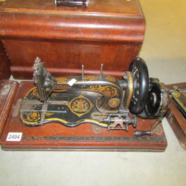 A vintage sewing machine with cover.