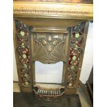 A reproduction Art Nouveau style fireplace in cast iron with a bronze effect featuring tiles and