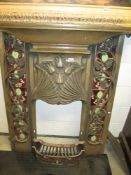 A reproduction Art Nouveau style fireplace in cast iron with a bronze effect featuring tiles and